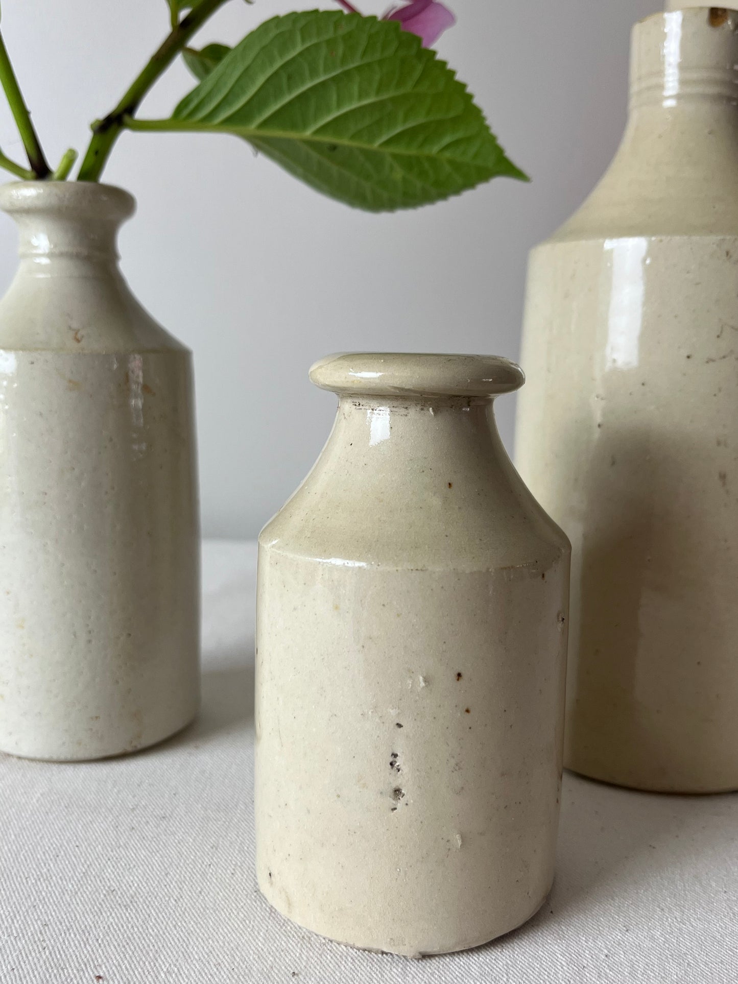 A Set of Three Stonewear Pots.