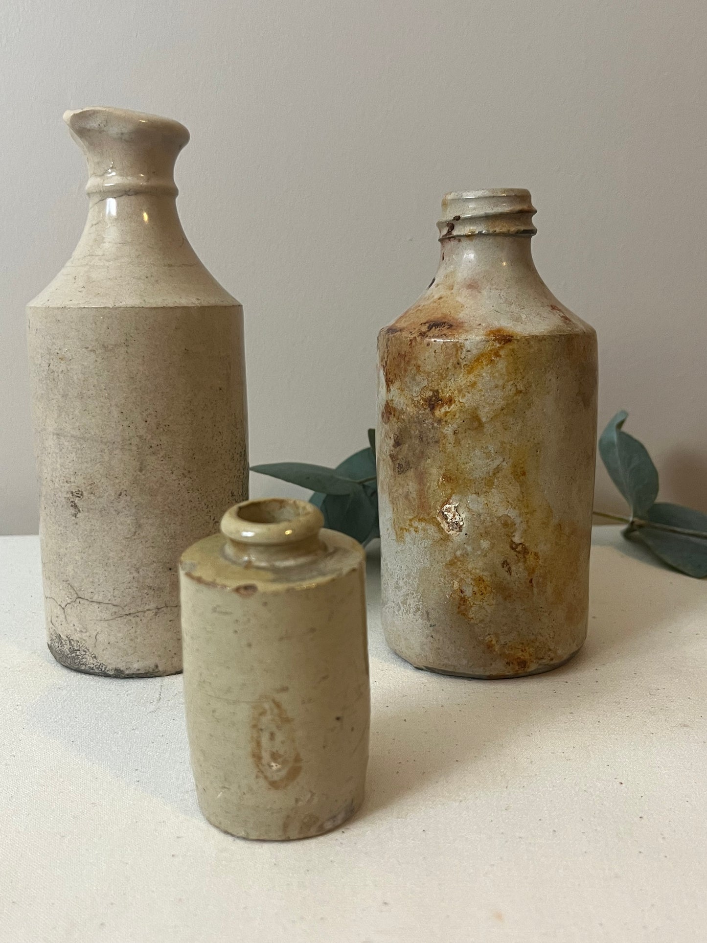 Set of Three Stoneware Bottles.