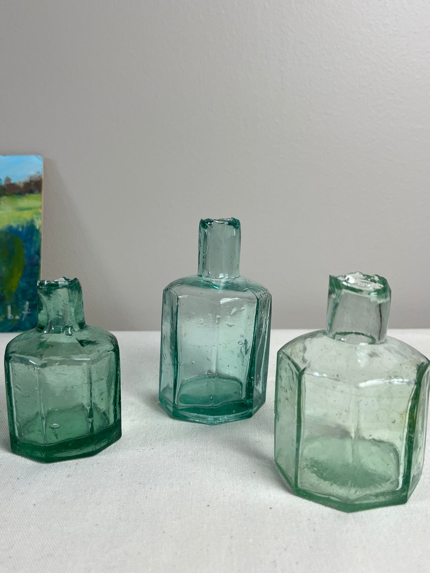 A set of Three Glass Ink Bottles.